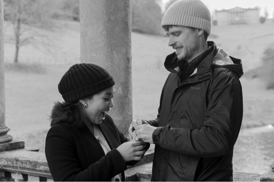 Cameron placing the ring on Thea's hand, moments after proposing