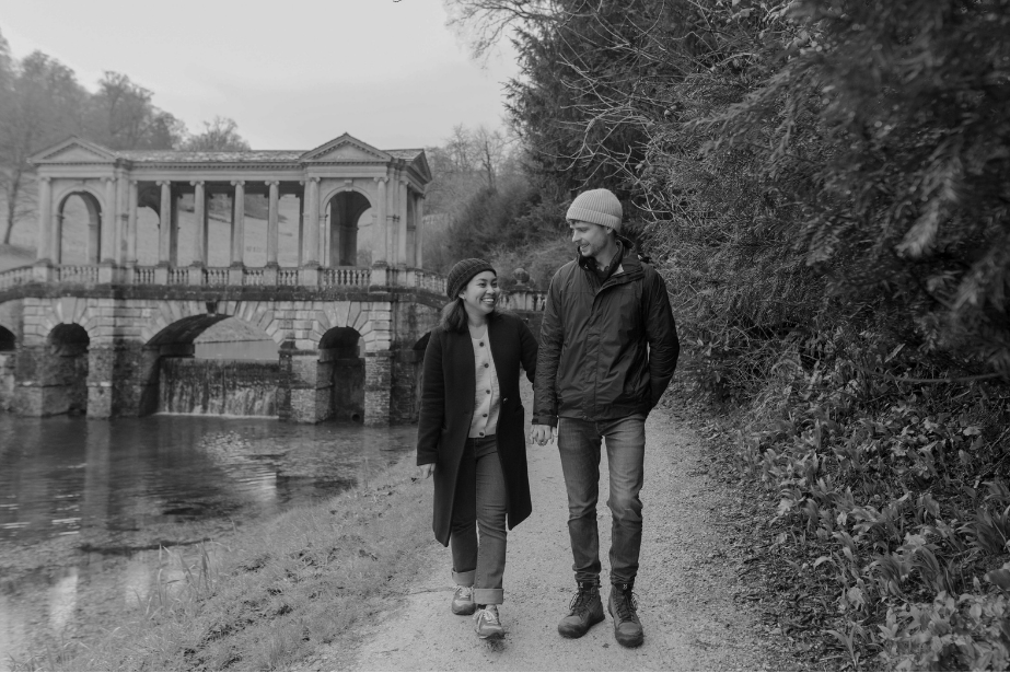 Cameron and Thea walking hand in hand along the lake path