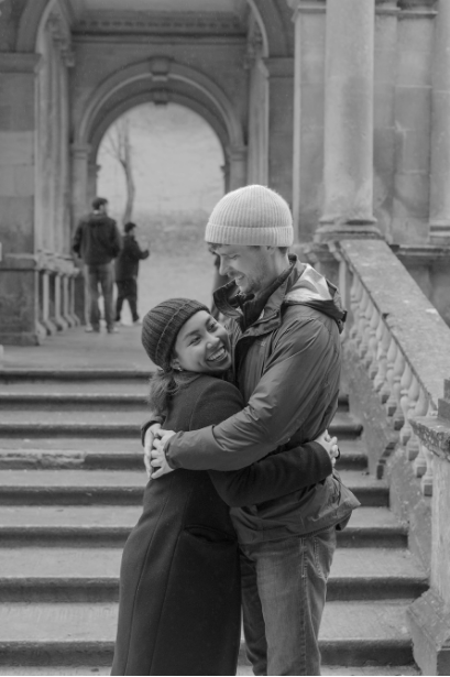 Cameron and Thea embracing on stone steps