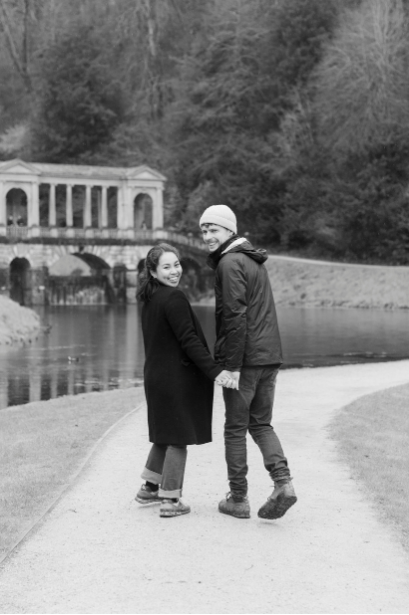 Cameron and Thea looking back over their shoulders as they walk together